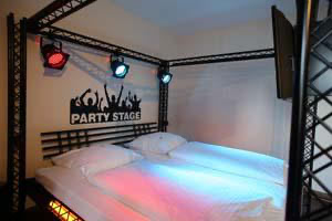 The colorfully lit disco bed in the disco theme room in the Hotel Beverland in Münster
